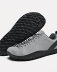 Dannto gray barefoot outdoor sneakers shown from a three quarter view and the bottom