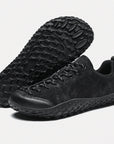 Dannto black barefoot trail shoes shown from a three quarter view and the bottom